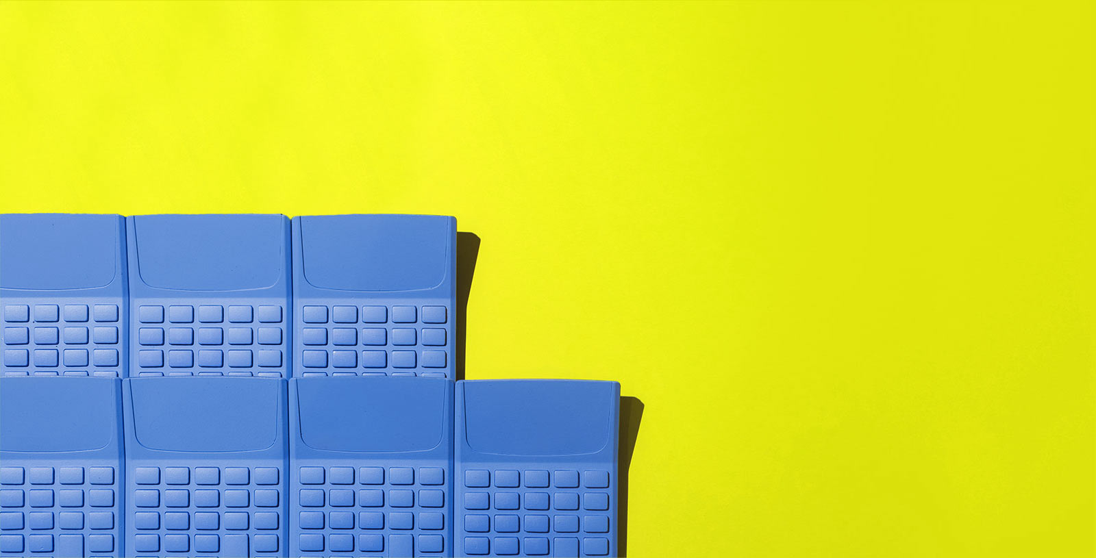 a group of blue calculators on a yellow background