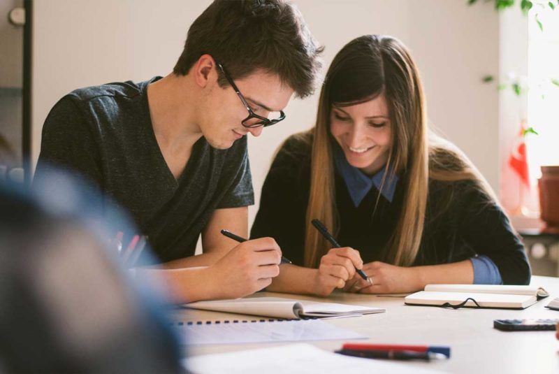 A man and a woman writing