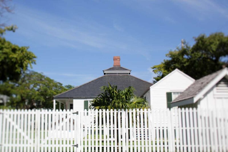 A property sits behind a fence with no residents visible.