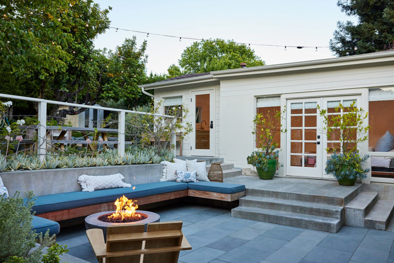 Luxurious home exterior with back deck and fire pit