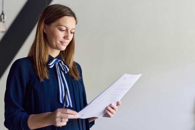 A female real estate attorney reviews a contract.