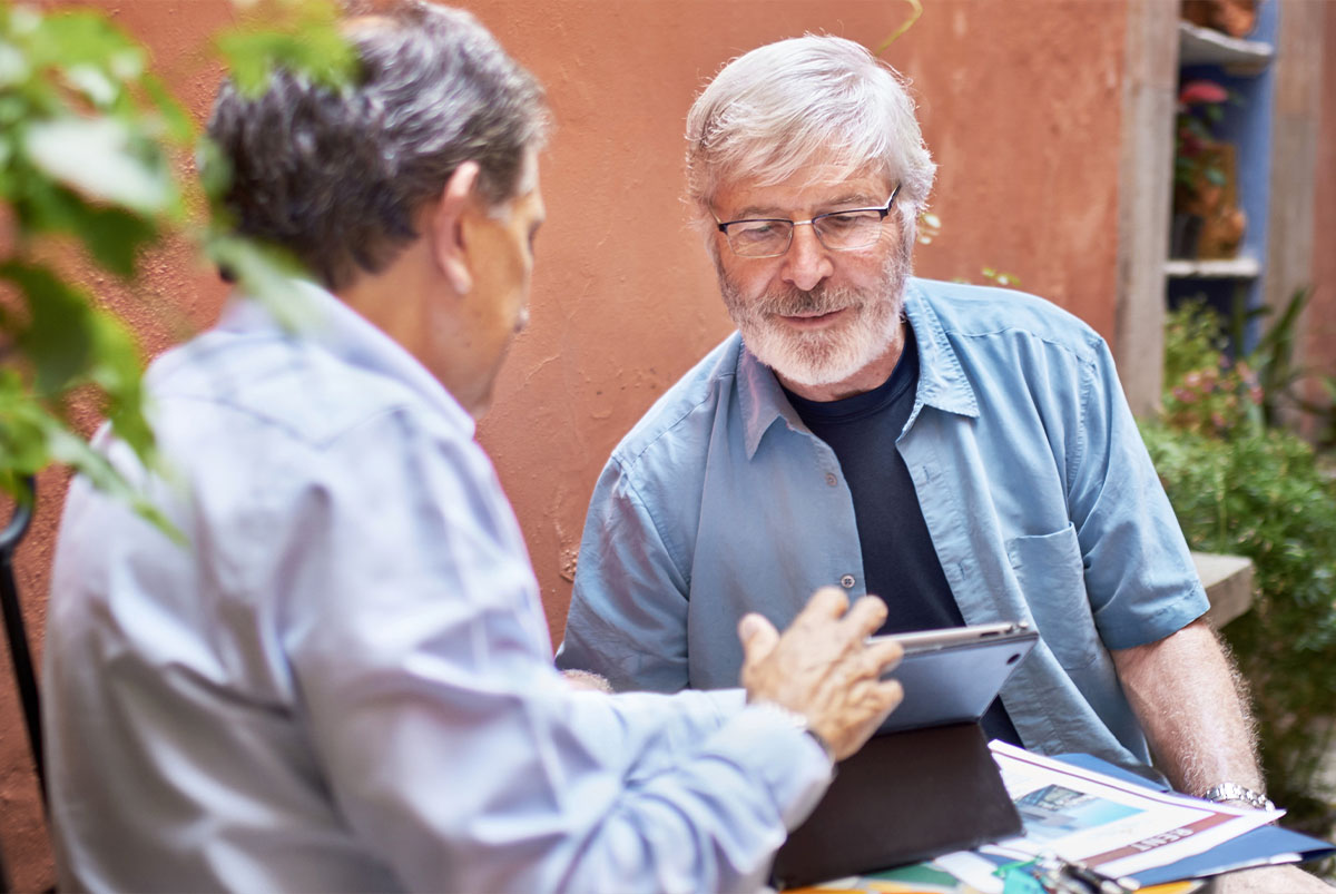 Client looking on real estate agent's tablet