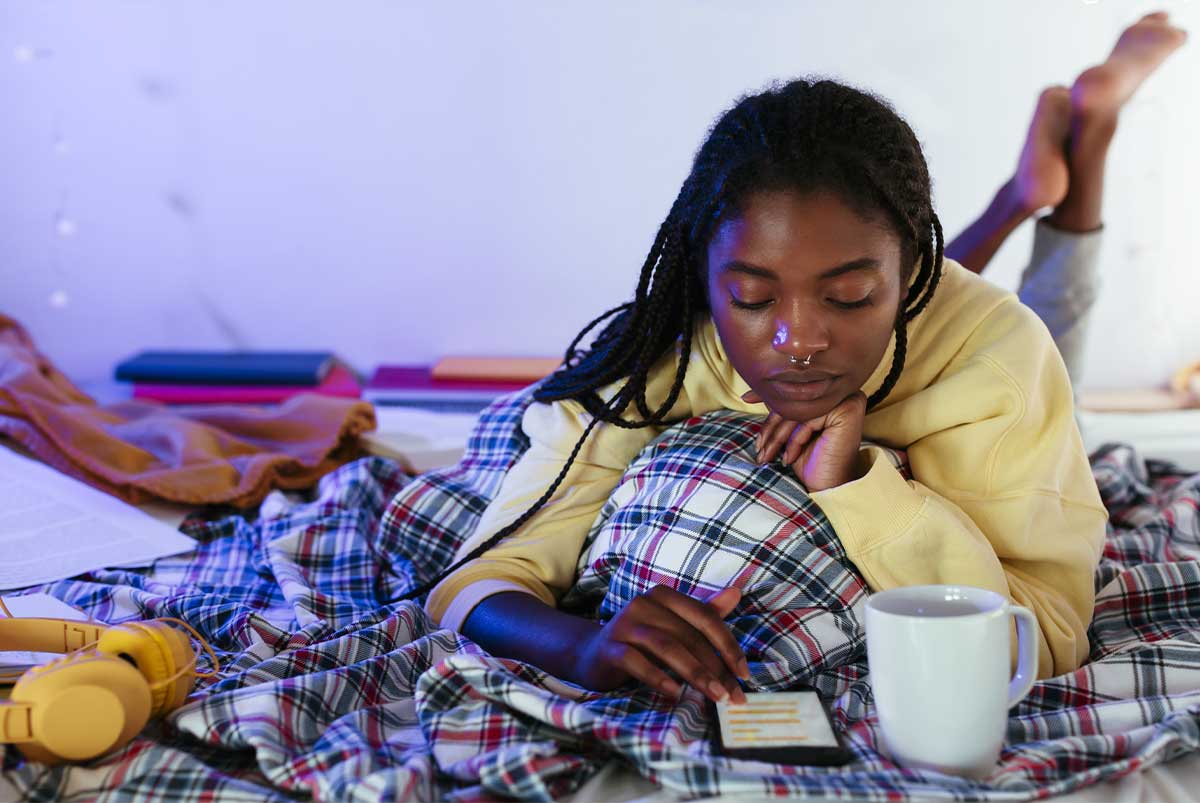 Teenager in bed with calculator