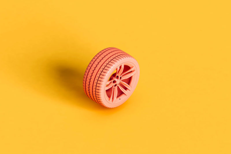 Pink tire on a yellow background