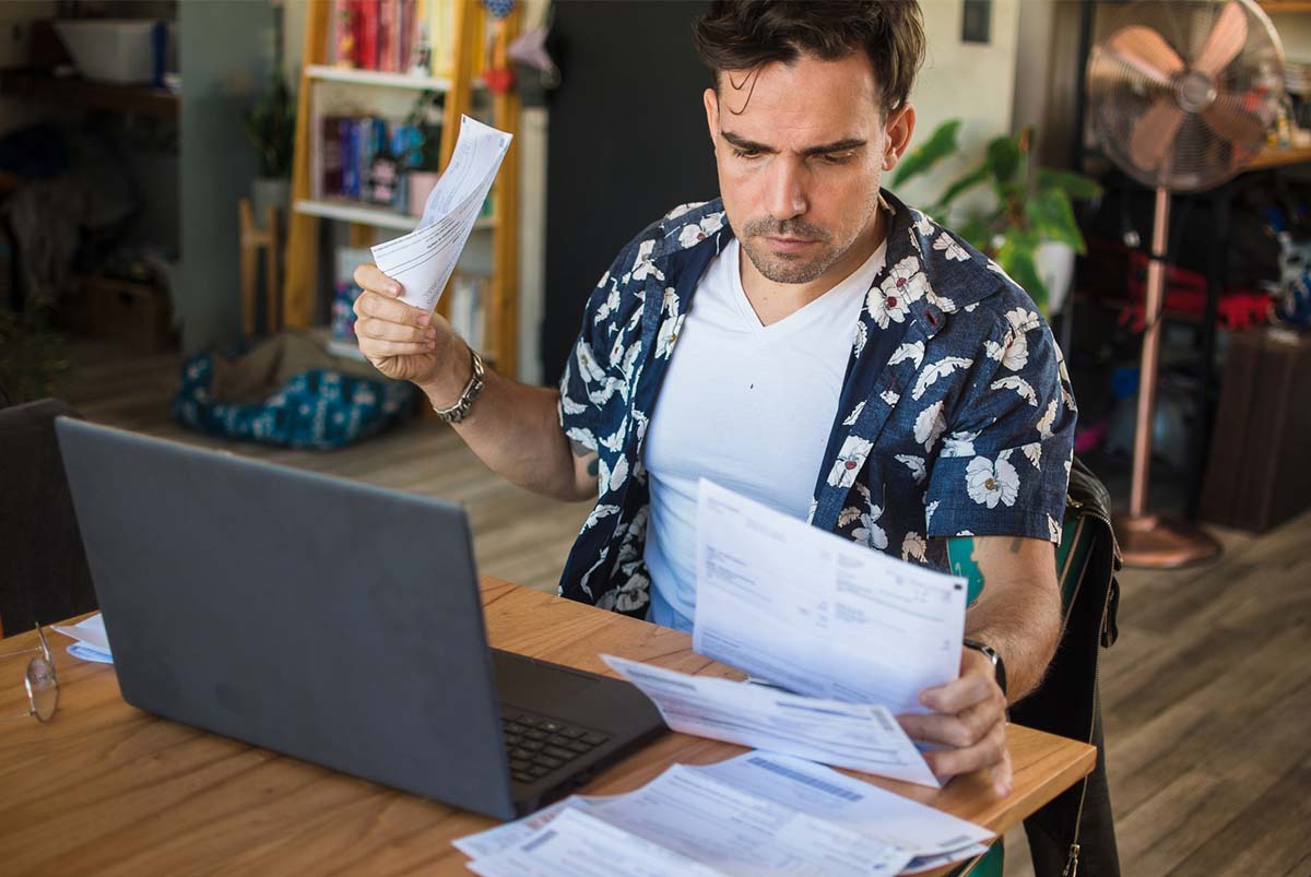 Man looking at paper bills