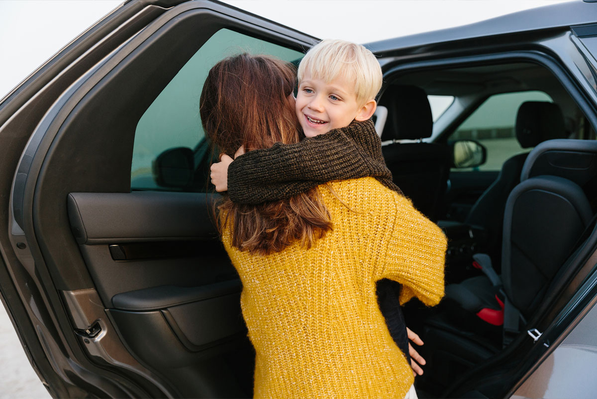 woman taking child out of car