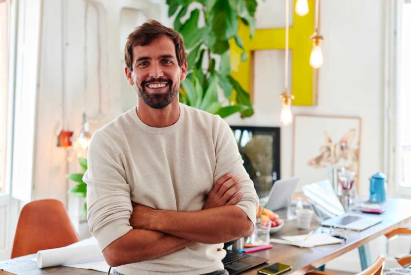 Man behind artsy home office desk