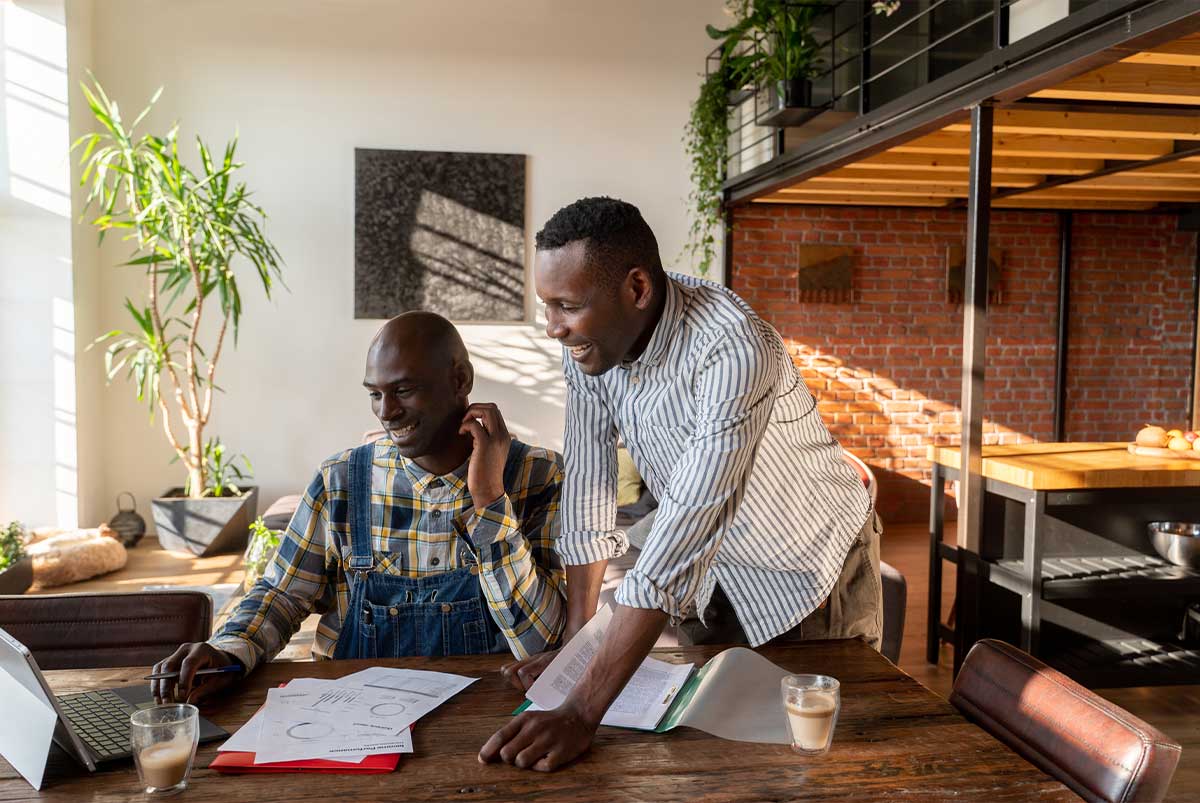 Two people looking at a laptop