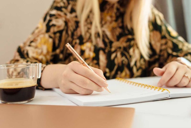 A student writing in a notebook