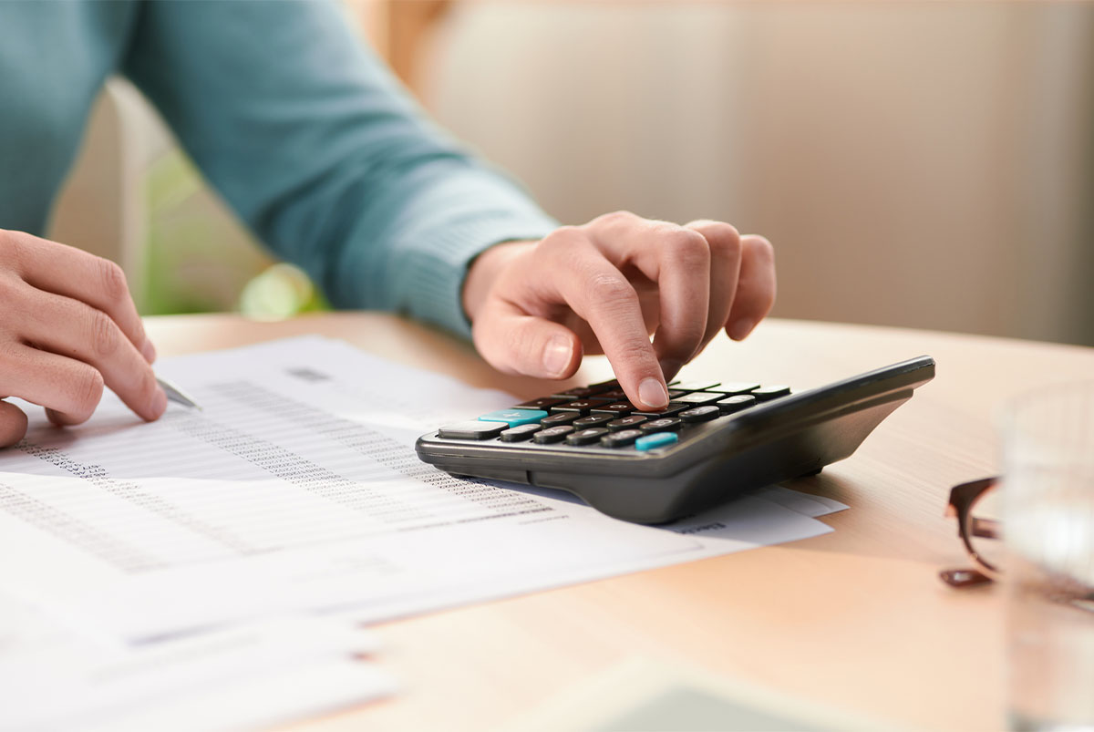 close up of hand using a calculator