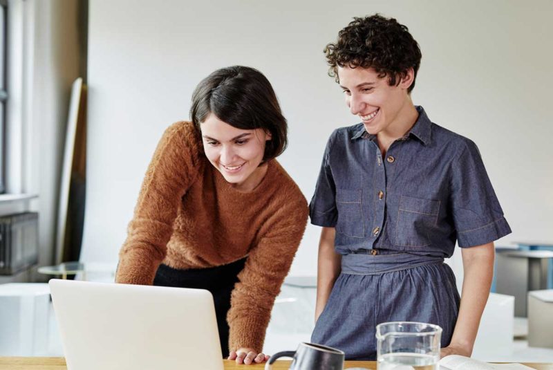 Two women looking at computer