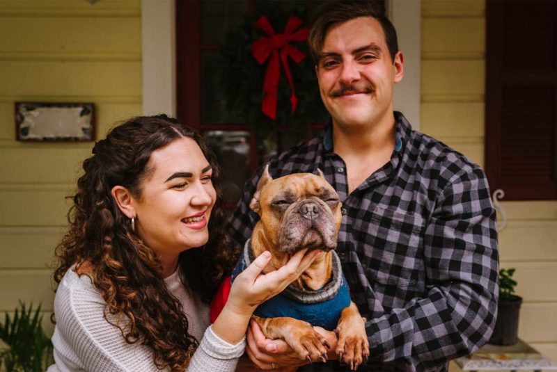 Couple holding a dog