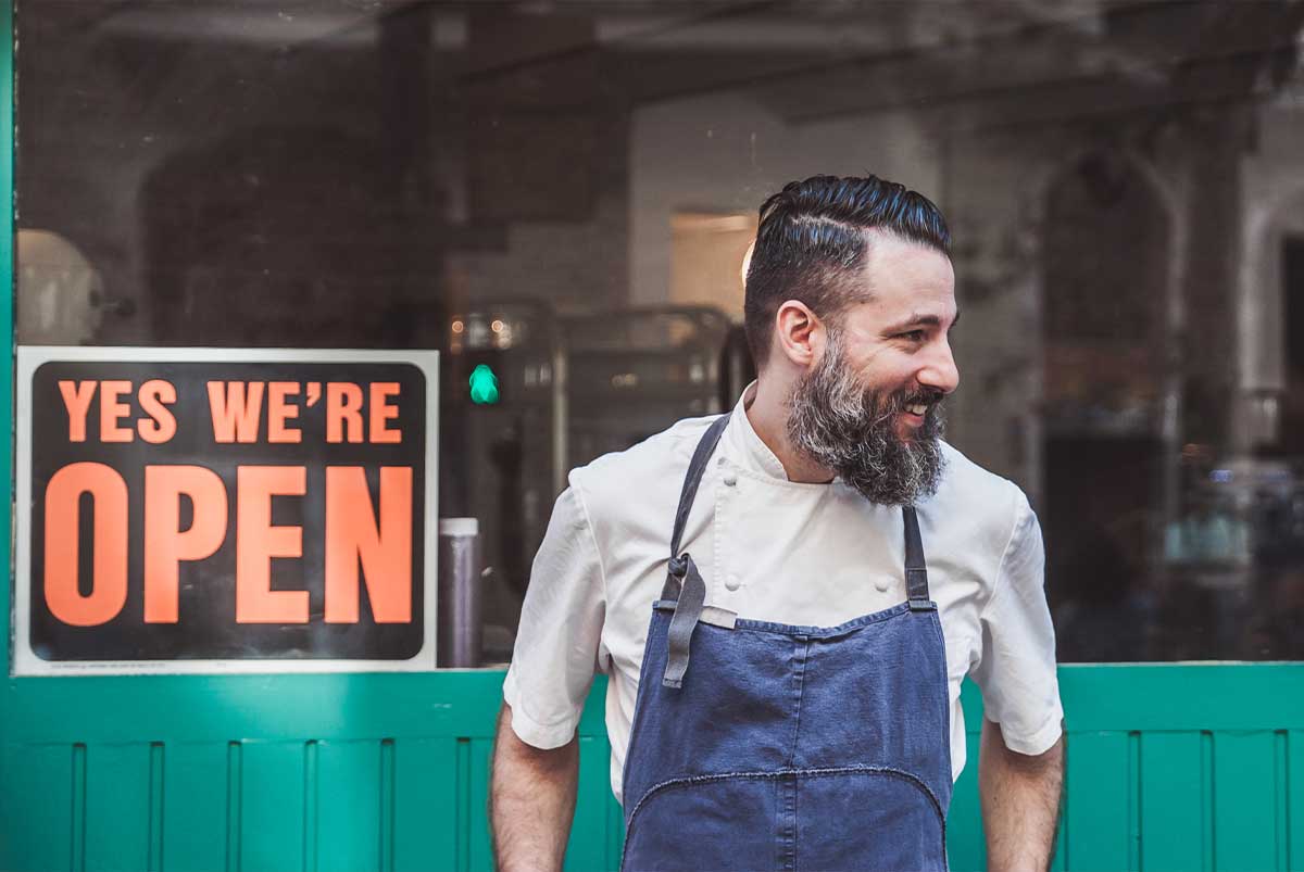 Man in front of small business