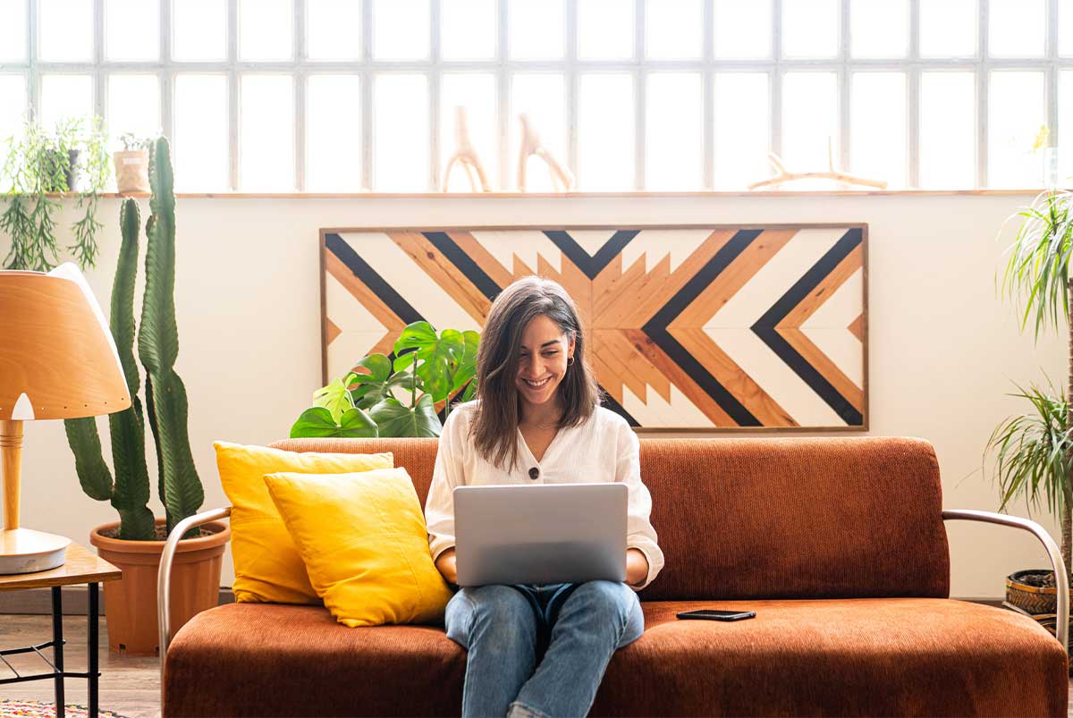 Woman on couch with laptop