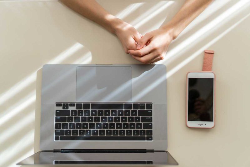 Person waiting next to a laptop