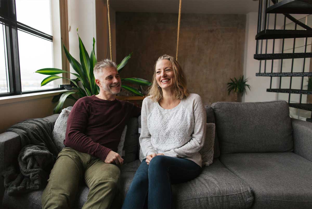 Couple sitting together on a couch.