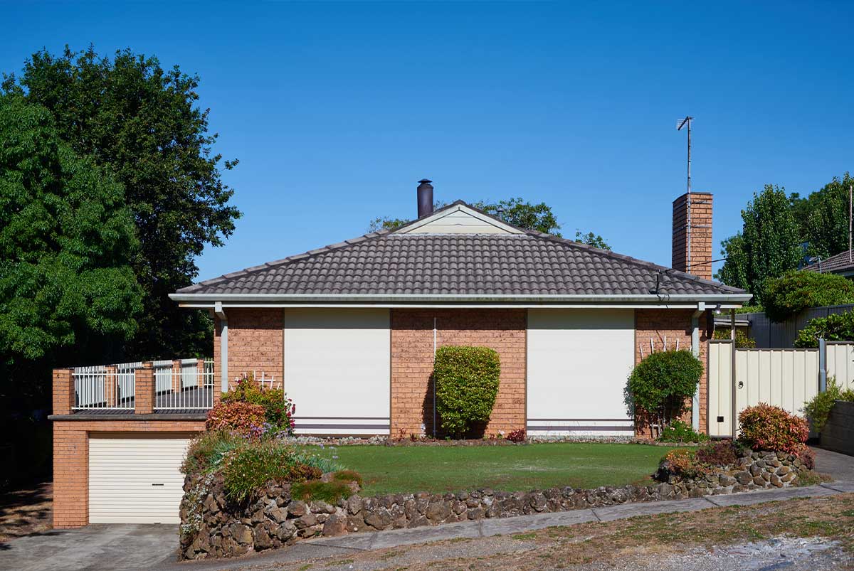 A split-level house with a small yard.