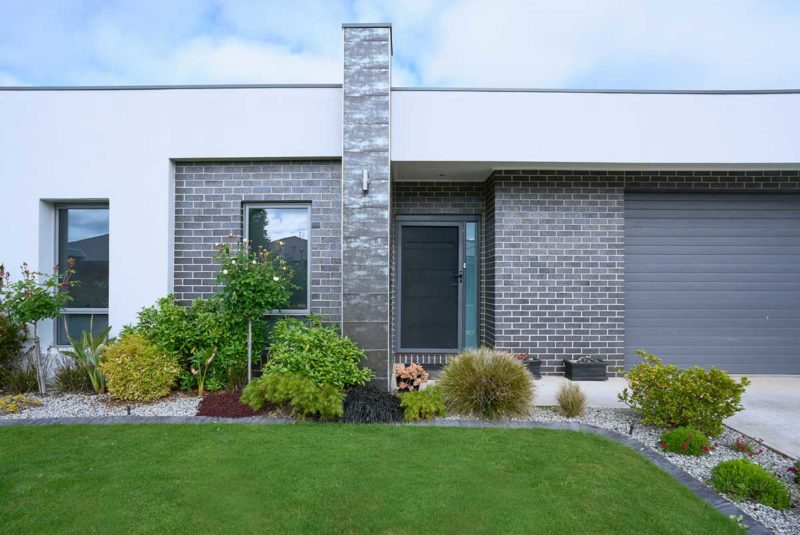 modern ranch home with lawn