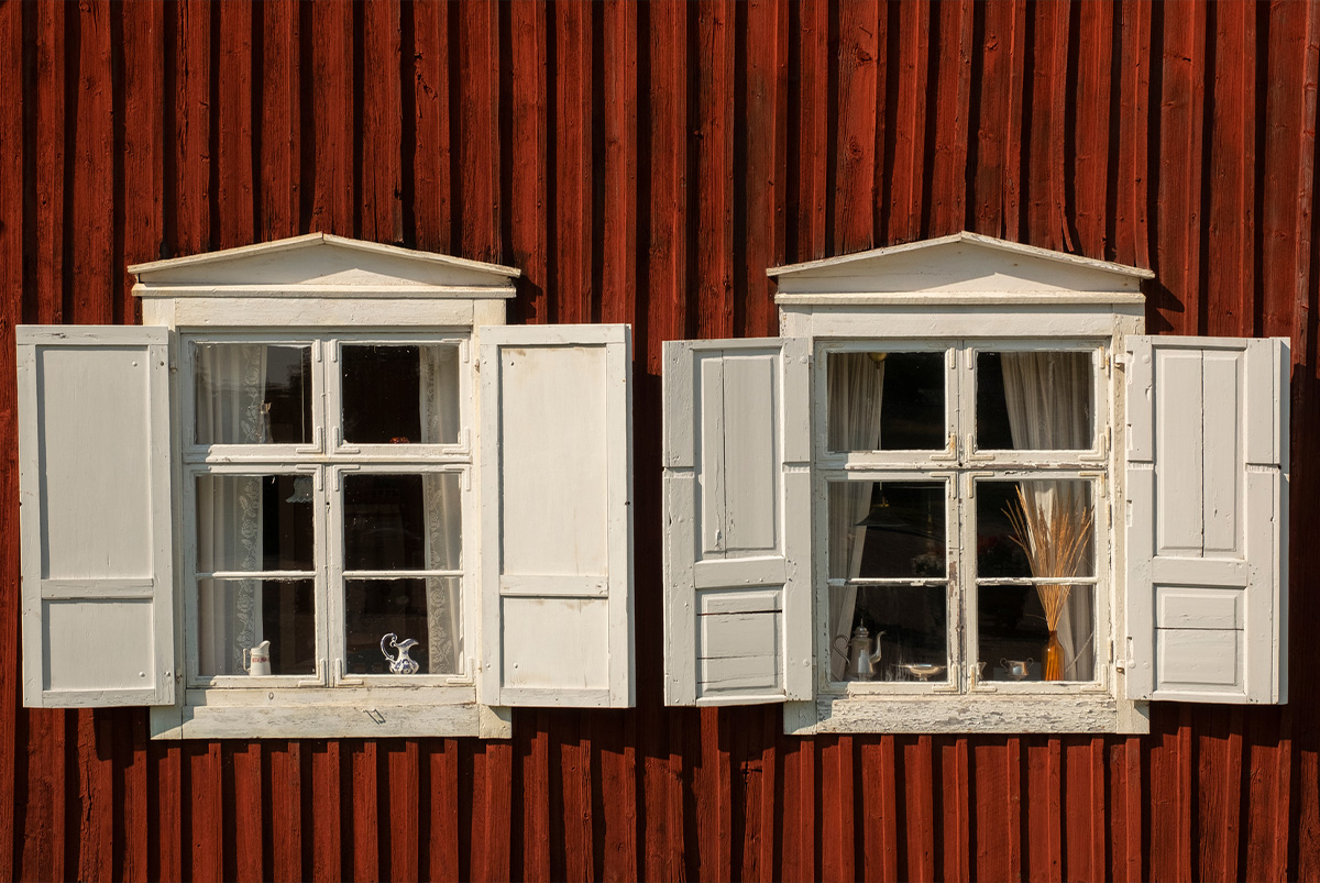 Side of house with dilapidated shutters