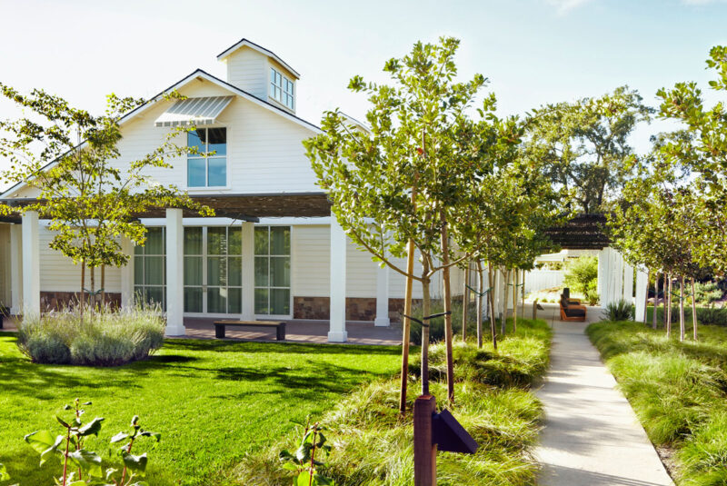 A picture of a house with a well-manicured landscape surrounding it.