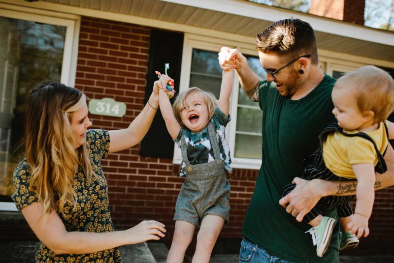 Family in front of brick house