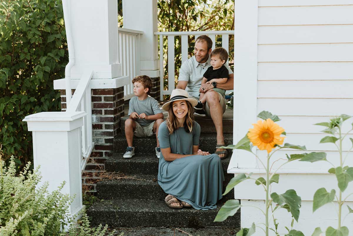 Family on front steps of home