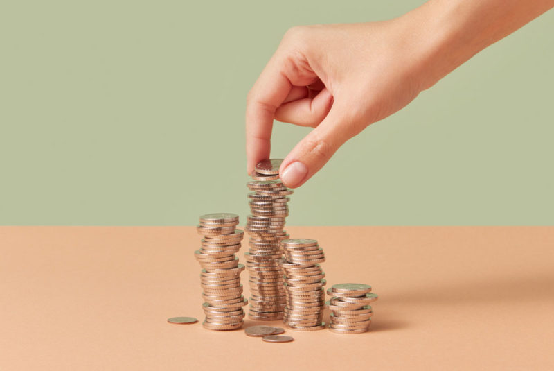 Coins being put in stacks by hand