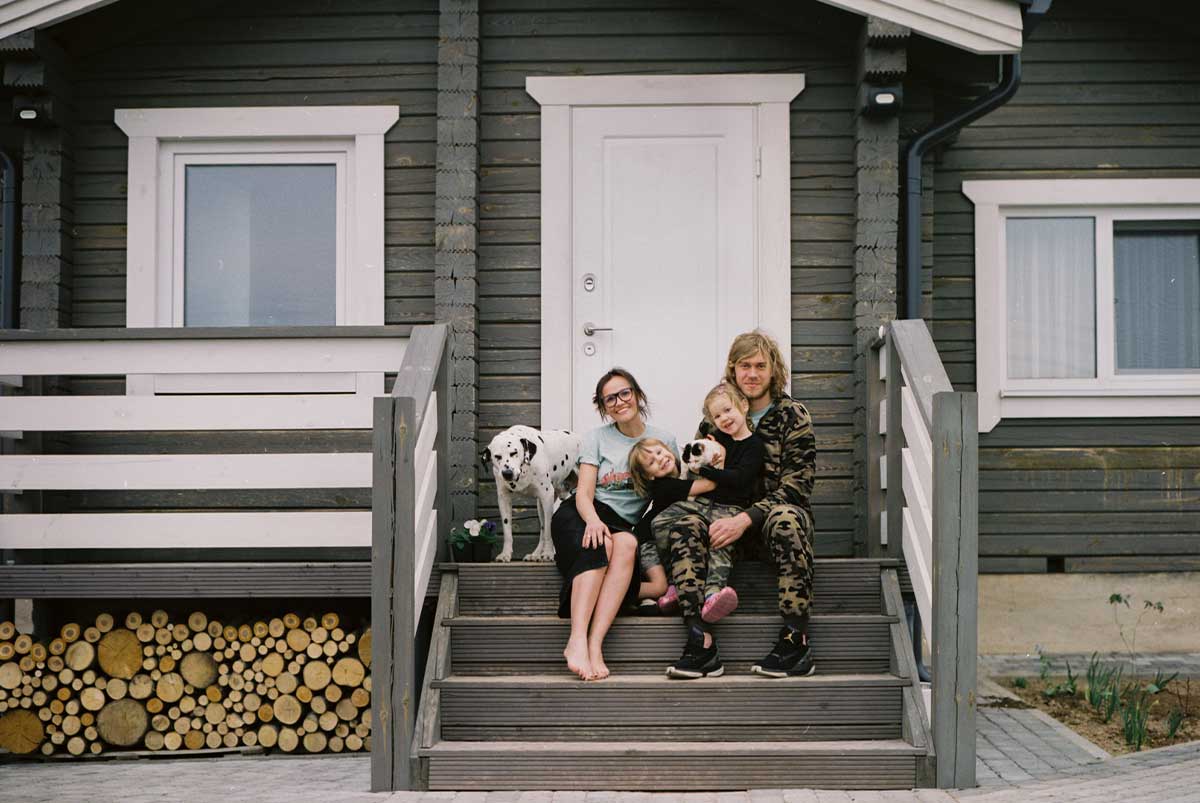 Family on front porch of cabin house