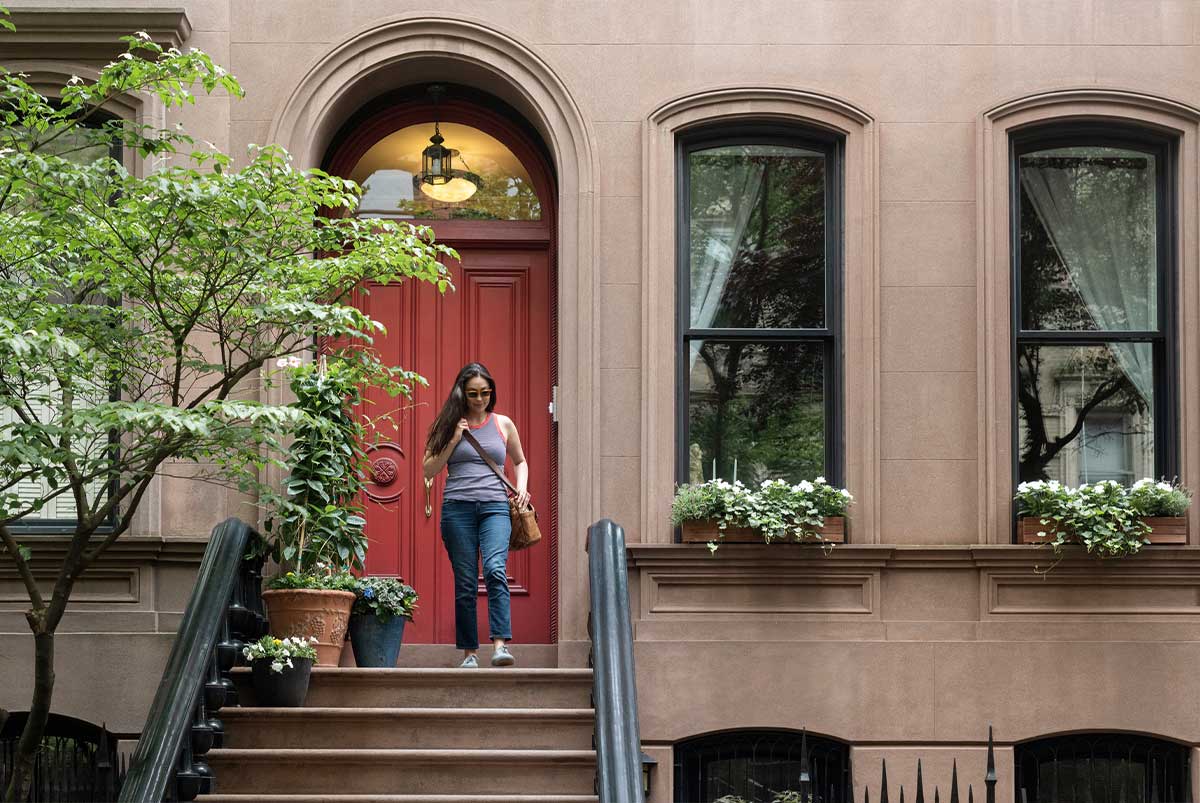 Woman in front of red door