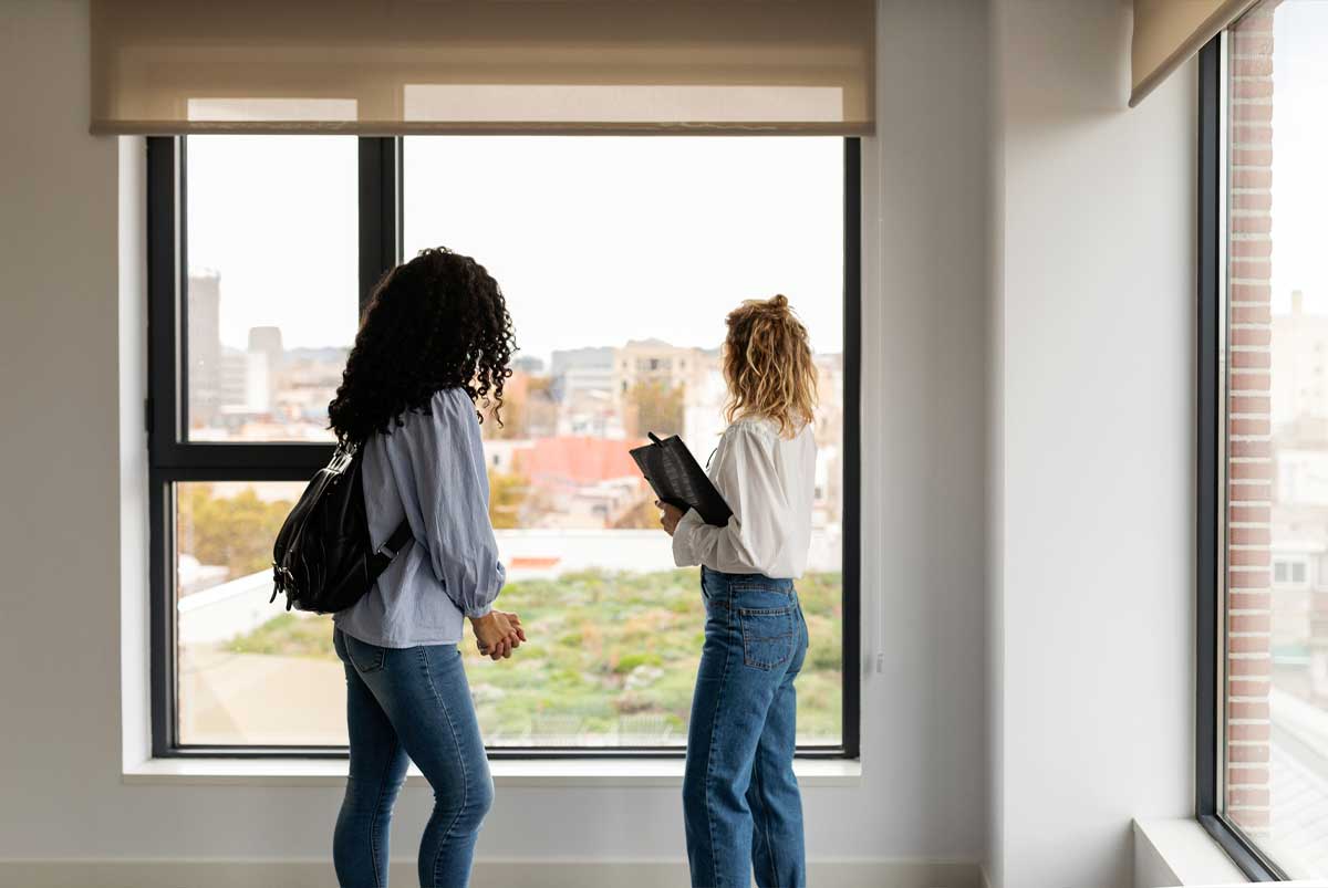 Two people looking out a window