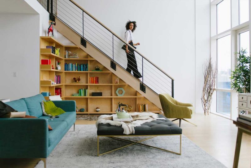 Woman walking down steps of modern home