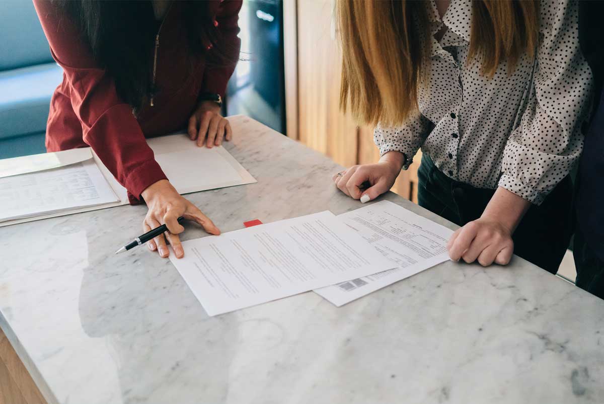 Two people looking at a contract