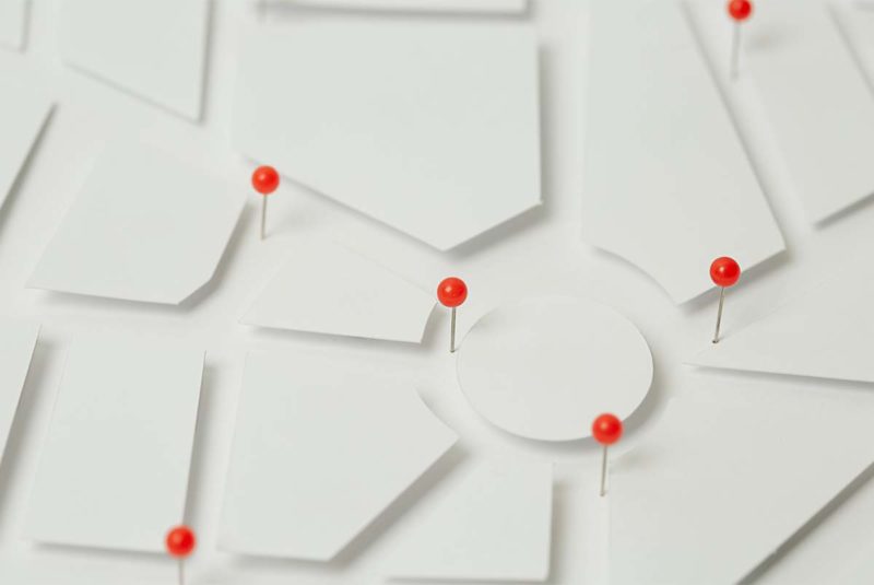 Red pins on white geometric map