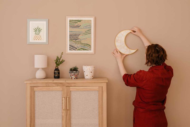 Woman hanging moon in home