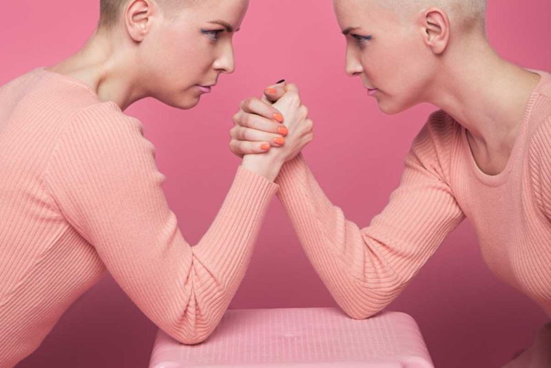 Two people arm wrestling